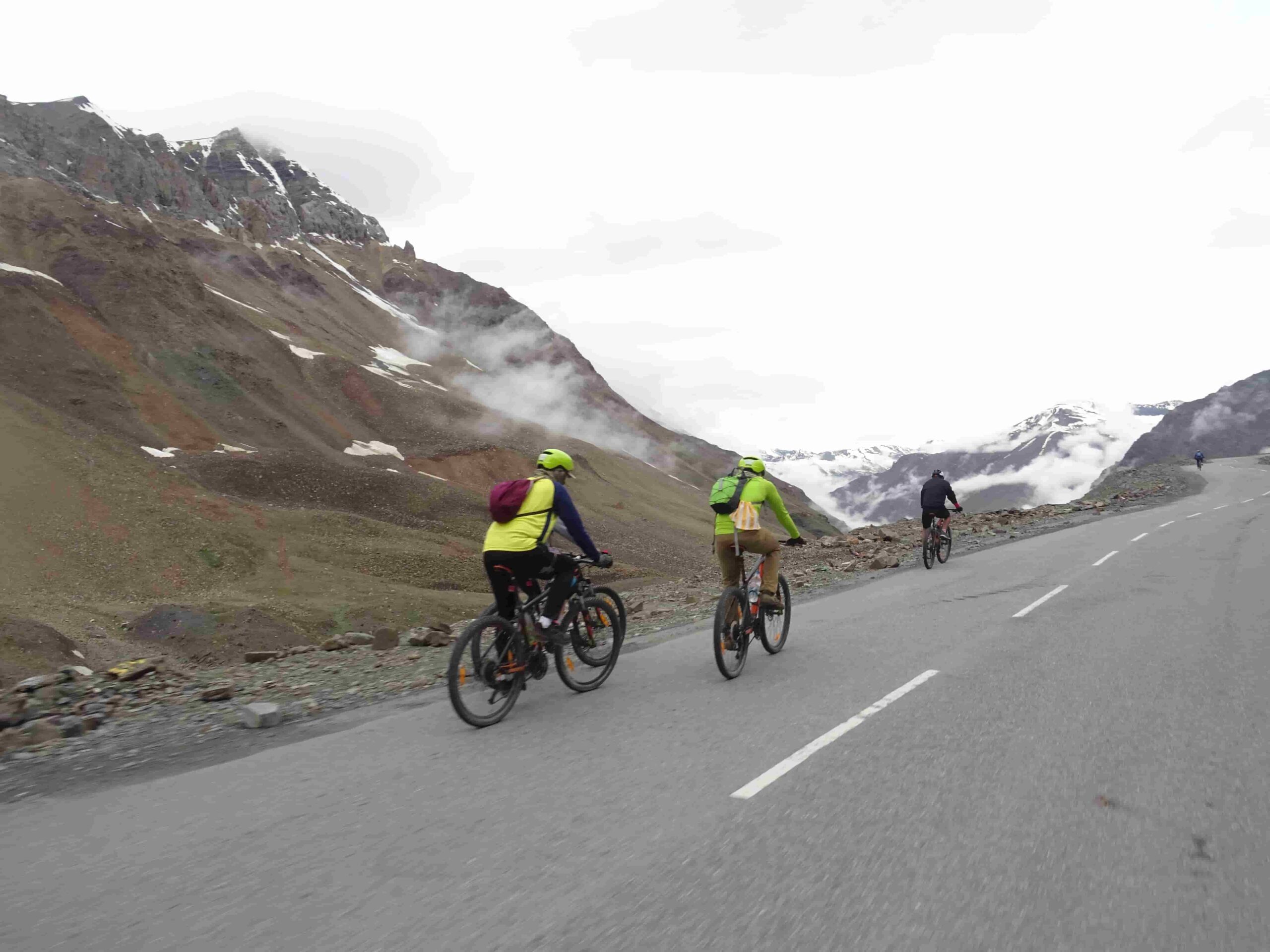 Cyclists riding a Himalayan mountain road on a guided cycling tour in India