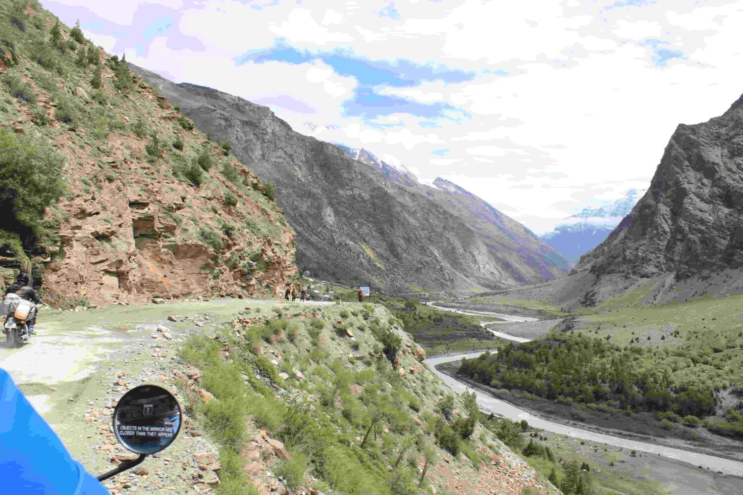 A breathtaking Himalayan valley with a river winding below the mountain roads explored on Into Wild Himalaya’s Foothills of the Himalayas Motorcycle Tour in North India.