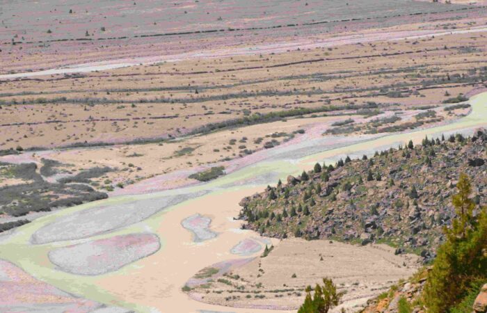 Aerial view of winding valley and turquoise river captured from Gata Loops while approaching Nakeela Pass on the Manali–Leh Highway