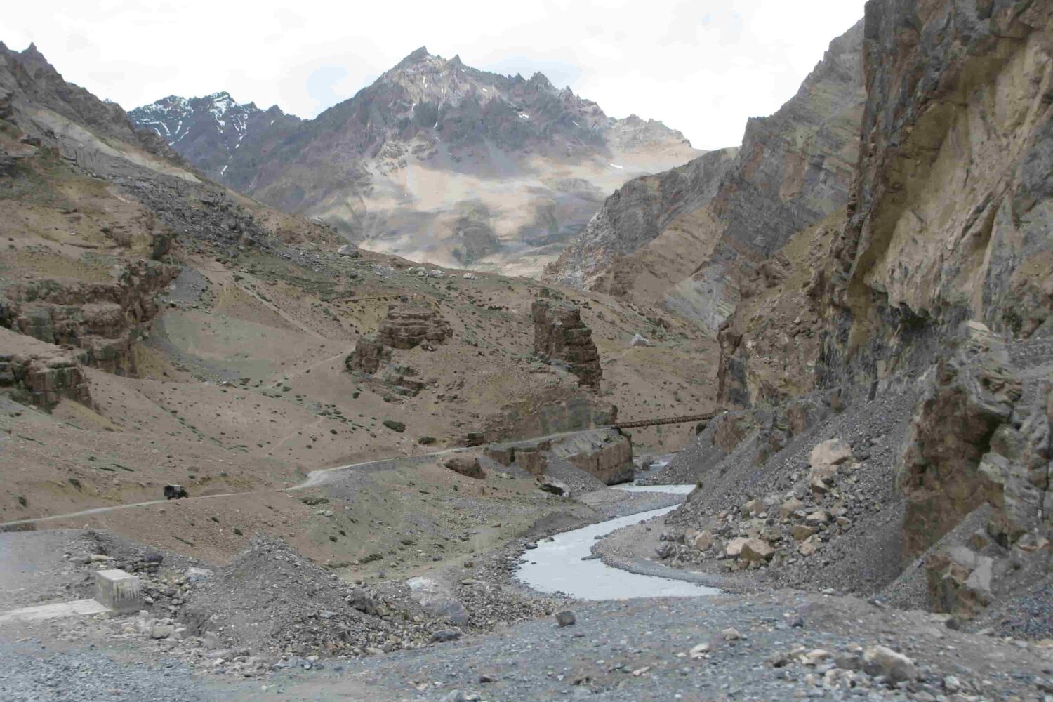 Bridge crossing over river valley on the off-road route to Spiti Valley during the Royal Enfield Motorcycle Tour with Into Wild Himalaya