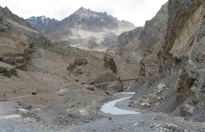 Bridge crossing over river valley on the off-road route to Spiti Valley during the Royal Enfield Motorcycle Tour with Into Wild Himalaya