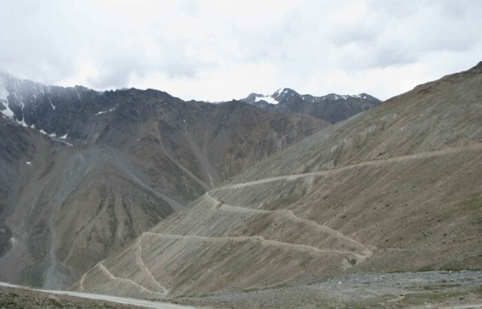 Loop bends below Kunzum La Pass in Spiti Valley on the route of the Royal Enfield Motorcycle Tour with Into Wild Himalaya