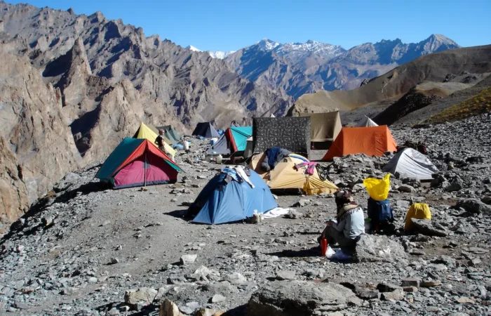 Trekking team crossing icy river during Zanskar Valley Trek, Padum–Reru–Darcha route, Indian Himalayas.