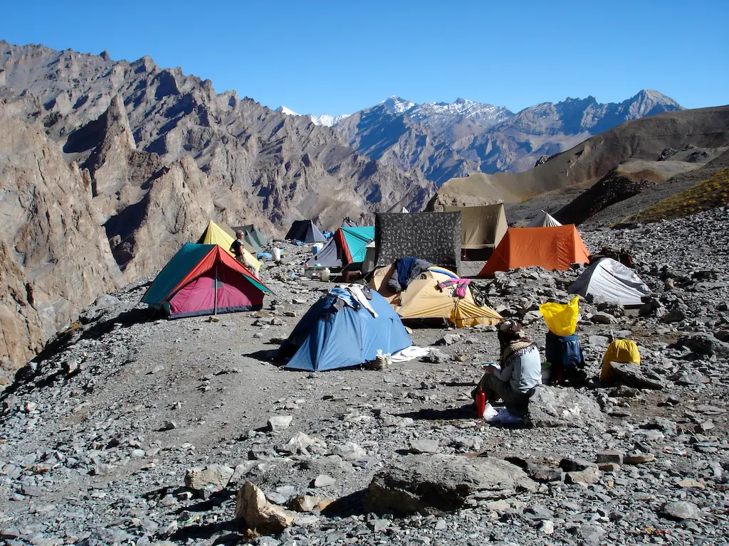 Trekking team crossing icy river during Zanskar Valley Trek, Padum–Reru–Darcha route, Indian Himalayas.