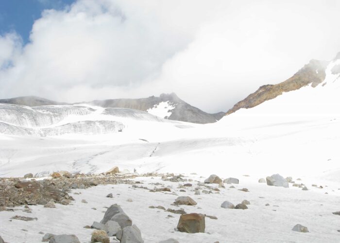 Glacier-covered high mountain pass at Pin Parvati Pass Trek in the Himalayas with snow and rugged terrain.