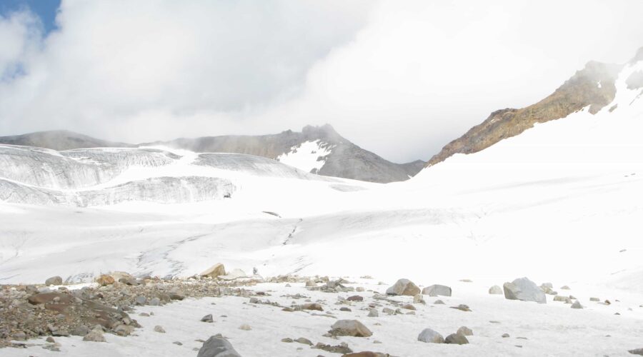 Glacier-covered high mountain pass at Pin Parvati Pass Trek in the Himalayas with snow and rugged terrain.