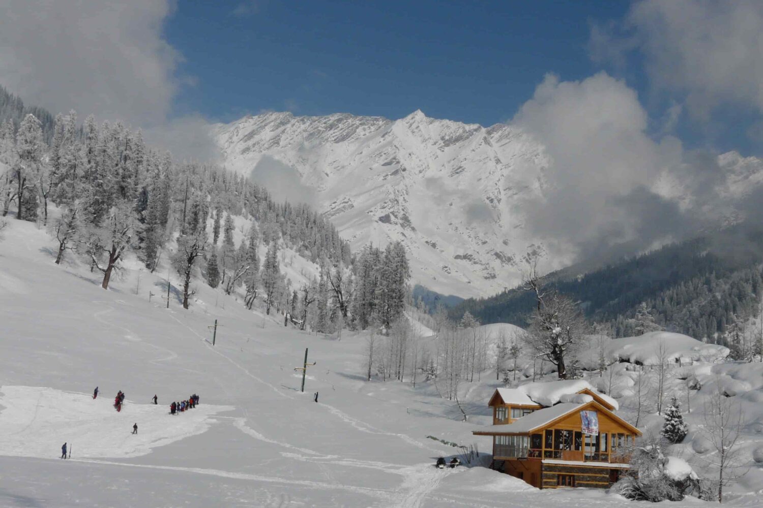 Winter trek and skiing in Manali with snow, mountains and guided Himalayan adventure experience.