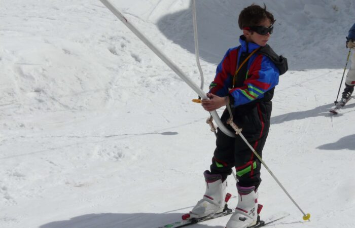 Skier gliding through fresh snow in Manali, Indian Himalayas during winter adventure training