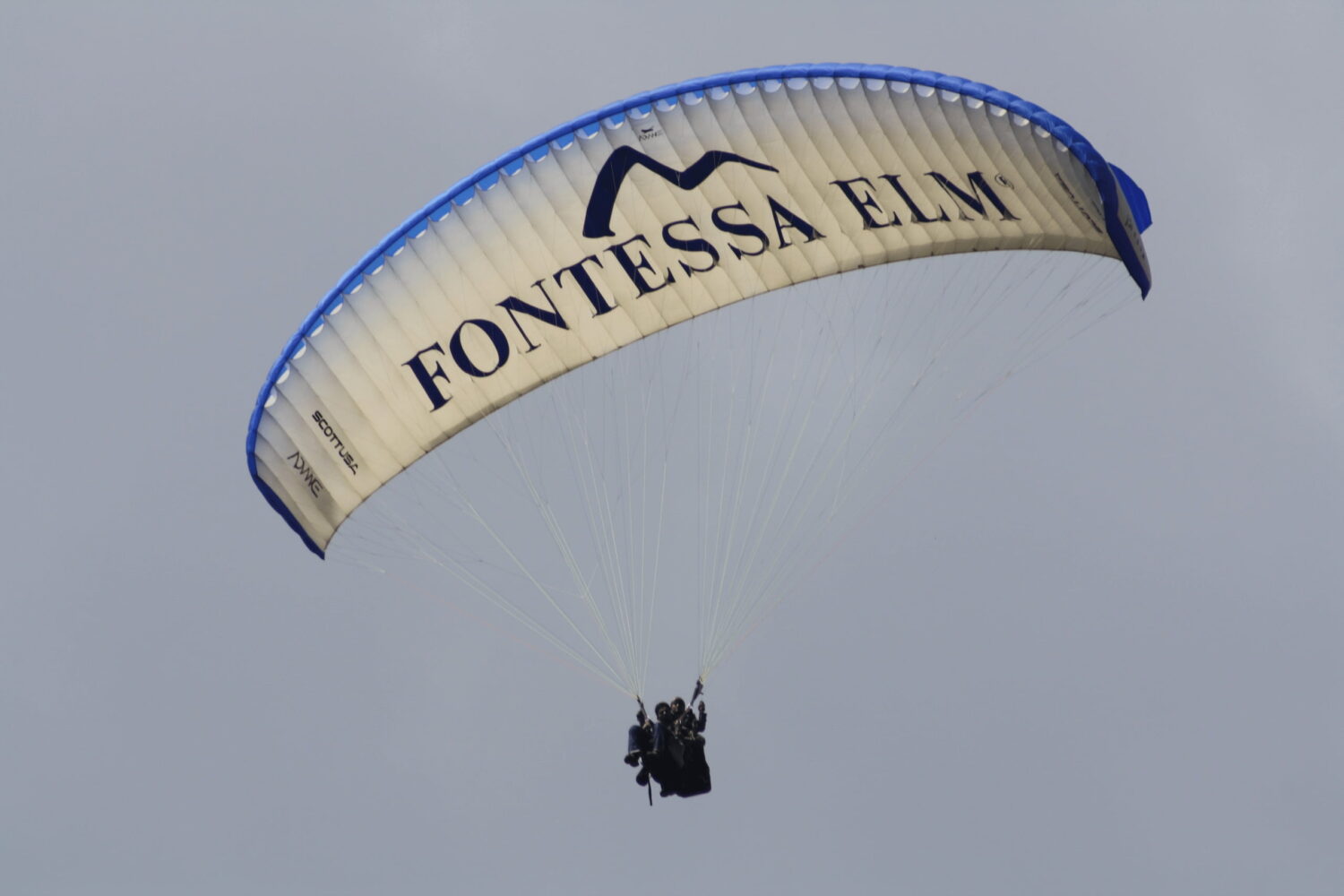 Instructor teaching beginner students basic paragliding control techniques on the training slope in Manali, Himachal Pradesh.