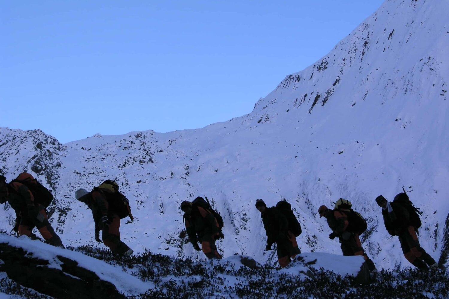 Trainees ascending a snow-covered Himalayan slope during the Private Basic Mountaineering Course in Manali India, practicing high-altitude movement and winter climbing skills.