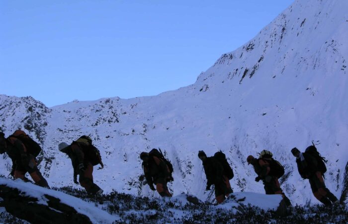 Trainees ascending a snow-covered Himalayan slope during the Private Basic Mountaineering Course in Manali India, practicing high-altitude movement and winter climbing skills.