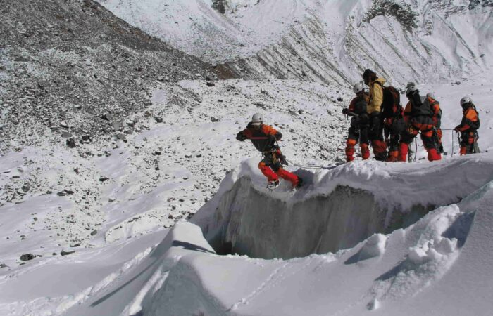Beginner mountaineering students practicing crevasse crossing and snow techniques during the Private Basic Mountaineering Course in Manali India, guided by certified instructors on Himalayan glacier terrain.