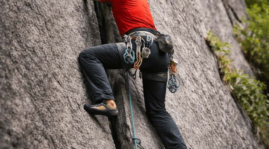 Rock climber practicing crack climbing technique in Sethan near Manali, Indian Himalayas with certified guides